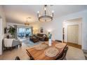 Open-concept living and dining area featuring a wooden dining table, a comfortable sofa, and sliding doors to the patio at 878 Franklin Cir, Palm Harbor, FL 34683