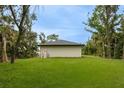 Expansive backyard with lush green grass offering plenty of space for outdoor activities at 18146 Sinatra Ave, Port Charlotte, FL 33954