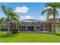 This home includes a screen-enclosed pool with a beautiful view of a nearby pond at 20115 Nob Oak Ave, Tampa, FL 33647
