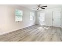 Bright bedroom features wood-look flooring, and ample natural light from two windows at 2101 E Ellicott St, Tampa, FL 33610