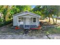 Inviting single-story home with a welcoming front porch and well-maintained yard at 2101 E Ellicott St, Tampa, FL 33610