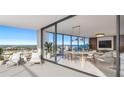 Bright condo balcony features patio furniture and city views leading into a modern dining and living space at 235 1St S Ave # 3501, St Petersburg, FL 33701