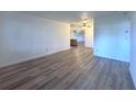 Spacious living room featuring wood panel walls and ceiling fans, seamlessly flowing into other rooms at 3234 37Th N St, St Petersburg, FL 33713