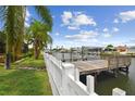 A private dock with a white picket fence and beautiful waterfront views at 3921 E Eden Roc Cir, Tampa, FL 33634