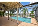 Screened-in pool area with a spacious patio, perfect for outdoor entertaining and relaxation at 3921 E Eden Roc Cir, Tampa, FL 33634
