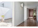 Stylish entryway featuring tiled floors, a modern light fixture, and a view of an open courtyard at 4104 Northmeadow Cir # 4104, Tampa, FL 33618