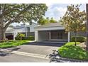 Single Gathering home with a covered carport, manicured lawn and mature shade trees at 4104 Northmeadow Cir # 4104, Tampa, FL 33618