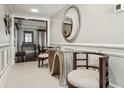 Hallway with decorative mirror, decorative table and chairs plus view into living area at 4104 Northmeadow Cir # 4104, Tampa, FL 33618