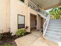 Charming home exterior with neat landscaping, featuring stairwell access to upper-level units at 316 Kelsey Way # 316, Sun City Center, FL 33573