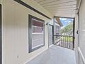 Screened porch featuring a window, door, and neutral color scheme at 3964 Dream Oak Pl # 203, Tampa, FL 33613