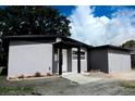 Stylish single-story house featuring a gray exterior, tidy landscaping, and a modern entrance at 4720 Murray Hill Dr, Tampa, FL 33615