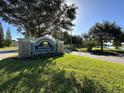 Stone sign welcomes residents to Baywood Summerwood with manicured landscaping at 8819 Walnut Gable Ct, Riverview, FL 33578