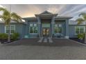 Inviting front exterior with double doors, elegant landscaping, and a well-maintained gravel pathway at 9016 Falcon Ct, Venice, FL 34293