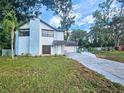 Inviting two-story home with stone accents, well-manicured lawn, and a paved driveway at 10928 Echo Loop, New Port Richey, FL 34654