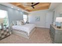 Spacious bedroom with plush bed, ample natural light, and stylish dresser at 7814 Hidden Creek Loop # 104, Lakewood Ranch, FL 34202