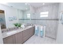 Elegant bathroom featuring double vanity, large shower, and modern fixtures at 7814 Hidden Creek Loop # 104, Lakewood Ranch, FL 34202