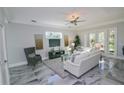 Spacious living room with white sofa and gray chair at 7780 Hidden Creek Loop # 104, Lakewood Ranch, FL 34202