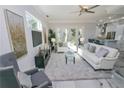 Bright living room with white sofa and view to backyard at 7780 Hidden Creek Loop # 104, Lakewood Ranch, FL 34202