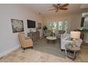 Bright living room with comfy seating and a large TV at 7730 Hidden Creek Loop # 102, Lakewood Ranch, FL 34202