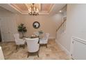 Formal dining area with a chandelier and four chairs at 7730 Hidden Creek Loop # 102, Lakewood Ranch, FL 34202