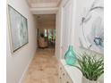 Elegant hallway with light tile flooring and art at 7730 Hidden Creek Loop # 102, Lakewood Ranch, FL 34202