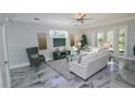 Spacious living room with white sofas and grey accents at 7834 Hidden Creek Loop # 104, Lakewood Ranch, FL 34202