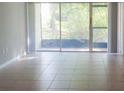 Bright living room with tile floors and sliding glass doors at 592 100Th N Ave # 102, St Petersburg, FL 33702