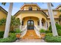 Elegant entrance with a grand staircase and wrought-iron doors at 1363 Oceanview Dr, Tierra Verde, FL 33715