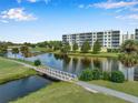 Condo building and golf course with pond and bridge at 1200 Country Club Dr # 6103, Largo, FL 33771