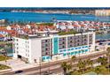 Modern condo exterior with rooftop terrace overlooking scenic waterway and lush palm trees at 400 150Th Ave # 302, Madeira Beach, FL 33708