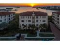 Luxury waterfront condo building at sunset, offering stunning views at 5715 Yeats Manor Dr # 201, Tampa, FL 33616