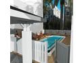 Community pool with lounge chairs and a fenced-in area at 11605 1St E St # B-3, Treasure Island, FL 33706