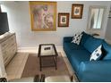 Cozy living room featuring a teal sofa, coffee table, and tasteful wall art at 3315 58Th S Ave # 218, St Petersburg, FL 33712