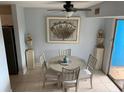 Bright dining area with a round table and four chairs, featuring unique artwork at 3315 58Th S Ave # 218, St Petersburg, FL 33712