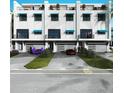 Front view of a row of townhouses, each with a private garage at 11605 1St E St # A-4, Treasure Island, FL 33706