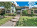 Green house with stone accents, double front doors, and a walkway at 2690 Keystone Rd, Tarpon Springs, FL 34688