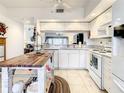 Bright kitchen with white cabinets and butcher block island at 960 Starkey Rd # 2303, Largo, FL 33771