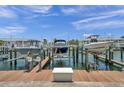 Three boats are docked on lifts at a waterfront community at 5174 Beach Se Dr # C, St Petersburg, FL 33705