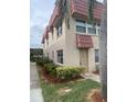 Exterior view of a condo building with red tile roofing at 10033 64Th N Ave # 1, St Petersburg, FL 33708