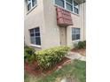 Exterior view of a condo building with a brown door at 10033 64Th N Ave # 1, St Petersburg, FL 33708