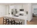 Modern kitchen with white cabinets, island, and stainless steel appliances at 600 3Rd S Ave # 209, St Petersburg, FL 33701