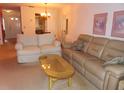 Spacious living room featuring comfortable sofas and a coffee table at 2341 Lake Heather Heights Ct # 2341, Dunedin, FL 34698
