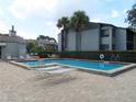 Inviting community pool with lounge chairs at 2341 Lake Heather Heights Ct # 2341, Dunedin, FL 34698