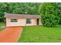 One-story house with orange driveway and large yard at 33466 Westwood Dr Dr, Ridge Manor, FL 33523