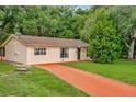One-story house with orange driveway and large yard at 33466 Westwood Dr Dr, Ridge Manor, FL 33523