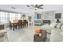 Bright living room with fireplace and dining area at 5603 80Th N St # 209, St Petersburg, FL 33709