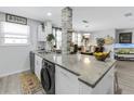 Open concept kitchen with island and laundry at 5603 80Th N St # 209, St Petersburg, FL 33709