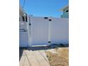 White vinyl gate provides access to the property at 15318 Harbor Dr, Madeira Beach, FL 33708