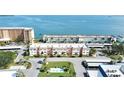 Aerial view of a waterfront condo building with a small pool and parking at 8 Glencoe Pl # 208, Dunedin, FL 34698