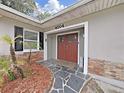 Attractive house exterior featuring a stone pathway and double doors at 4004 W Coachman Ave, Tampa, FL 33611